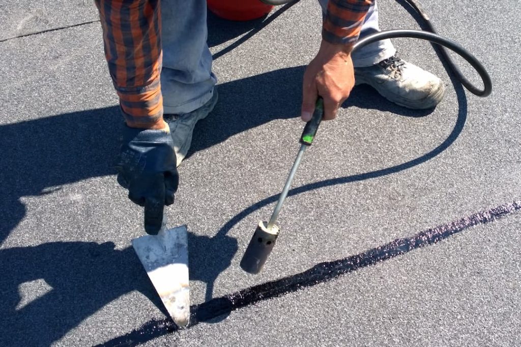 Roofer preparing felt roll